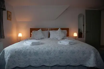 a bedroom with a large bed with two towels on it at Dunchraigaig House in Kilmartin