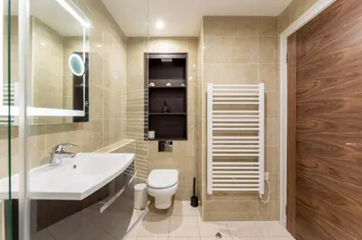 a bathroom with a white toilet and a sink at Gleneagles Apartment - Guthrie Court Gleneagles in Auchterarder