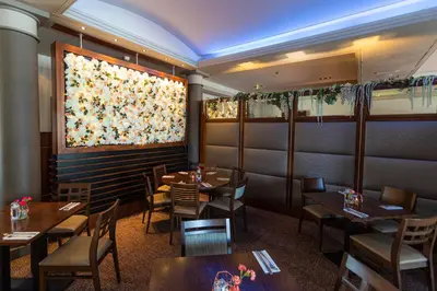 a restaurant with tables and chairs and a window at Fletcher's Restaurant Bar & Rooms in Stirling