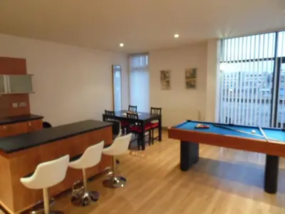 a living room with a pool table and chairs at Modern 2-bedroom Apt near SSE Hydro and SEC in Glasgow