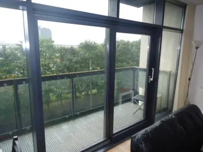 a living room with a view of a balcony at Modern 2-bedroom Apt near SSE Hydro and SEC in Glasgow