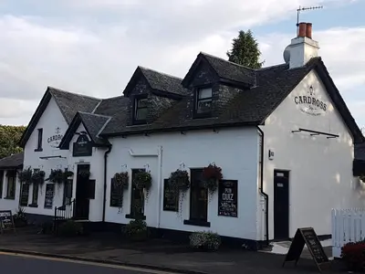 a white building on the side of a street at Cardross Inn in Cardross