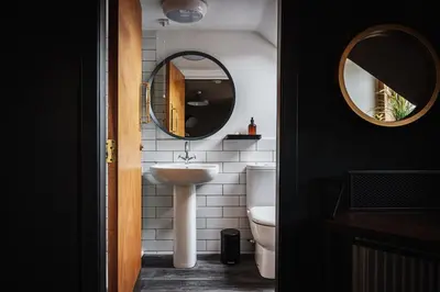 a bathroom with a sink and a mirror at Cardross Inn in Cardross