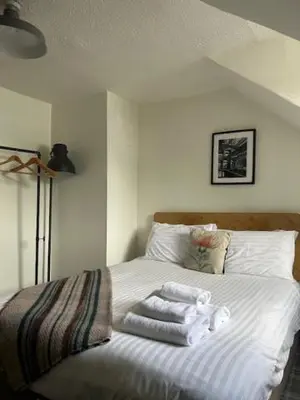 a bedroom with a bed with towels on it at Cardross Inn in Cardross