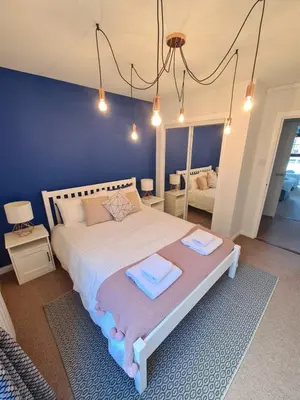a bedroom with a bed with two towels on it at Six Stevenson House, Oban in Oban