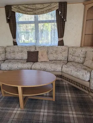 a living room with a couch and a coffee table at Lyndhurst 39 in Dunoon