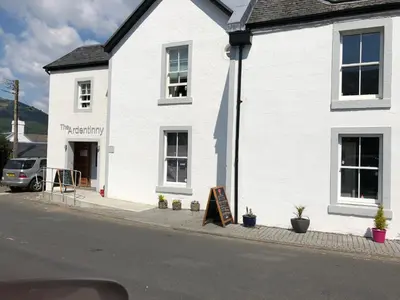 a white building with a sign in front of it at Lyndhurst 39 in Dunoon