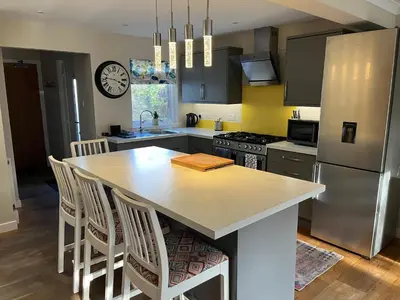 a kitchen with a kitchen island with a counter top at Kilmory Garden by the Loch in Lochgilphead