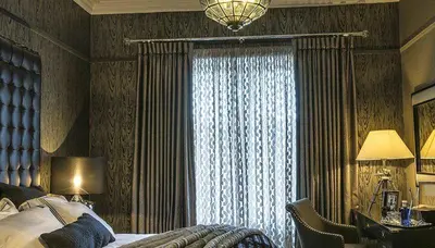 a bedroom with a bed and a large window at Ram Lodge in Moffat
