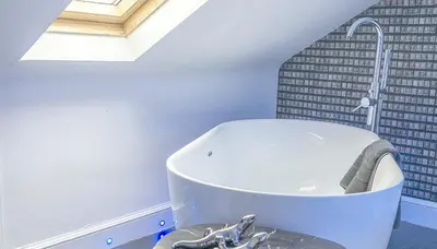 a white bath tub in a bathroom with a window at Ram Lodge in Moffat