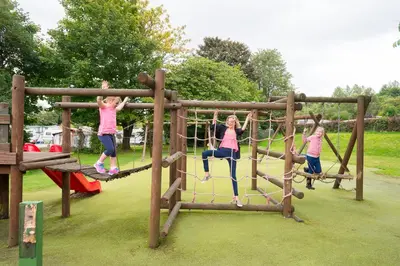 a group of children playing on a playground at Lomond Woods Holiday Park in Balloch