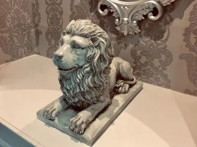 a statue of a lion sitting on a shelf at THE LION'S DEN ON ROYAL STREET in Gourock