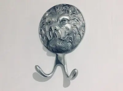 a silver pin with a lion head on a spoon at THE LION'S DEN ON ROYAL STREET in Gourock