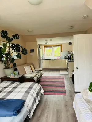 a living room with a bed and a couch at “A Wee Pad in Dunfermline” in Dunfermline