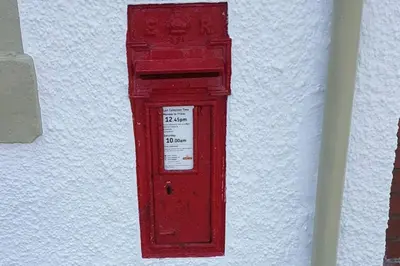 an old red post box on the side of a wall at Modern 1 bed Apartment close to Campbeltown in Campbeltown