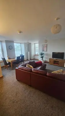 a living room with a couch and a table at Modern 1 bed Apartment close to Campbeltown in Campbeltown