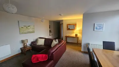 a living room with a couch and a table at Modern 1 bed Apartment close to Campbeltown in Campbeltown