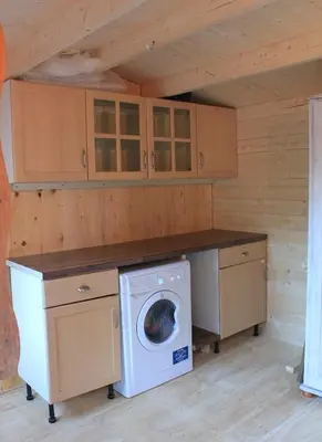 a laundry room with a washer and dryer at Arivonie Lochside Cottage in Glencoe