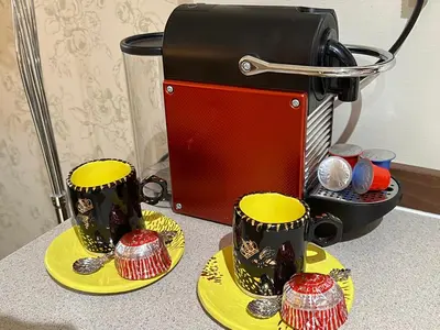 two cups on yellow plates next to a toaster at The Little Beech Tree in Linlithgow