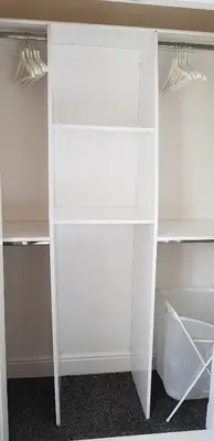 a white book shelf in a room at Home2Home Meadow Close in East Kilbride
