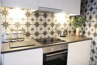 a kitchen with a counter top with stars on the wall at Boutique Bothy - Unique Bolthole in the New Town in Edinburgh
