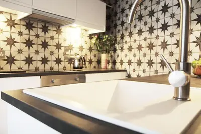 a kitchen counter with a white sink and a sink at Boutique Bothy - Unique Bolthole in the New Town in Edinburgh