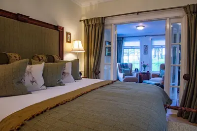 a bedroom with a large bed in a room at Kilmeny in Ballygrant