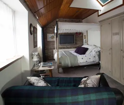 a living room with a couch and a bed at Langside Bed and Breakfast in Fenwick