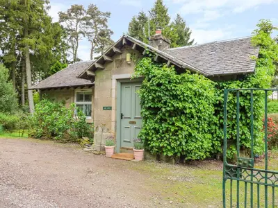 a small house with a green door at Gate Lodge in West Calder