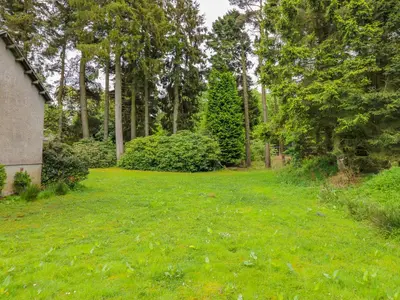 a yard with green grass and trees at Gate Lodge in West Calder
