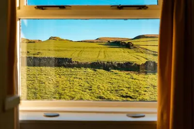 a window with a view of a field of grass at Kilchrist Castle Cottages in Campbeltown