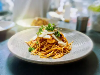 a plate of food with noodles on a table at Inversnaid Bunkhouse in Inversnaid