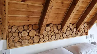 a room with a bunch of logs on the wall at The Lodge on the Loch by OYO in Onich