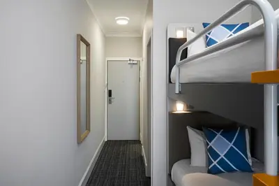 a room with a bunk bed and a mirror at Four Points Flex by Sheraton Edinburgh in Edinburgh