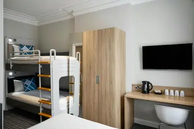 a hotel room with a bunk bed and a tv at Four Points Flex by Sheraton Edinburgh in Edinburgh