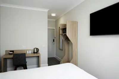 a room with a bed and a desk with a tv at Four Points Flex by Sheraton Edinburgh in Edinburgh