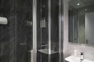 a bathroom with a glass shower and a sink at Four Points Flex by Sheraton Edinburgh in Edinburgh