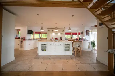 an open kitchen with white cabinets and a tile floor at Knockderry Lodge -Private Luxury pet-friendly accommodation in Scotland with hot tub in Cove