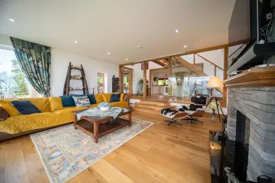 a living room with a yellow couch and a fireplace at Knockderry Lodge -Private Luxury pet-friendly accommodation in Scotland with hot tub in Cove