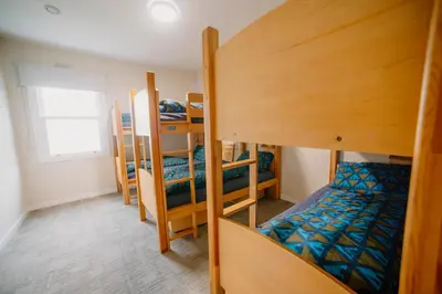 a room with three bunk beds and a bed at Rowardennan Youth Hostel in Rowardennan