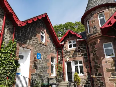 an old brick house with a turret at Rowardennan Youth Hostel in Rowardennan