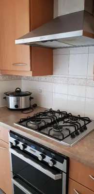 a kitchen stove with a pot on top of it at Meadow House- Driveway Parking and Fireplace in East Kilbride