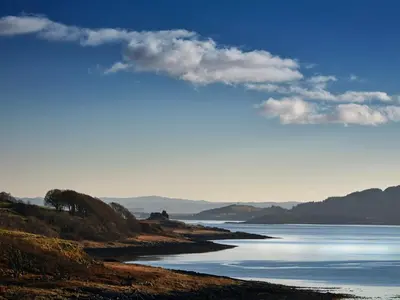 a view of a body of water with mountains in the background at Red Watch Apartment in Oban