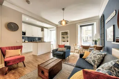 a living room with a couch and chairs and a table at GuestReady - Spacious and Beautiful 2BR Flat in Morningside in Edinburgh