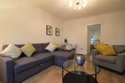 a living room with a couch and a table at Signature - Bruce Terrace Lower in High Blantyre
