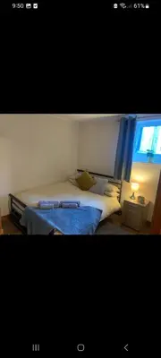 a bedroom with a bed and a window at Panoramic Harbour View Apartment in Oban