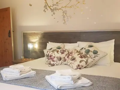 a bedroom with a bed with towels on it at Haagwood Cottage in Cretshengan