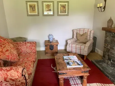 a living room with a couch and a coffee table at A Fairytale Highland Cottage in Aberfeldy