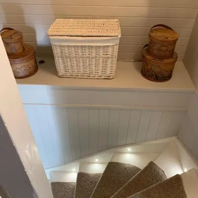 a white shelf with a basket and some containers at A Fairytale Highland Cottage in Aberfeldy