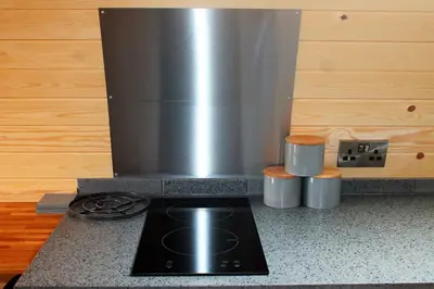 a stove top oven in a kitchen with a counter at Cairnfold Cabins in Kilsyth